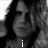 Black-and-white image of a person with long hair, showing text elements 'i', 'heart', and 'criss' across different sections.