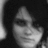 Black-and-white pixelated image of a person with dark hair and smudged eye makeup, accompanied by text in blocky white font on black background.