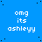 Blue background with white pixelated text 'omg its ashleyy' repeated in a pattern, scattered black dots, and a solid gray rectangle in the bottom-right corner