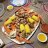 A pixelated static image shows a plate of food with yellow and brown items on a light surface.