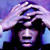 Pixelated static image of a person with dark hair and purple lighting against a gradient background, appearing as an AOL Instant Messenger buddy icon.