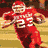 A football player in a red uniform with number 25 runs on a field, captured across showing motion and action