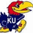 Pixelated cartoon bird with red head, yellow beak and feet, blue body, white text "KU" on chest, open mouth showing dark interior.