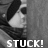 Pixelated grayscale image of a person's face in profile with the word STUCK! displayed below, rendered in blocky white text on dark background.