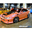 A 48x48 pixel buddy icon featuring a split composition with an orange race car on the left and blue text reading "GIRLY RACER HOLLA!" on the right, plus a pink section below stating "Made At Buddy Icon Editor .com" in purple text.