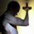 Pixelated image of a figure holding a cross against a gradient background with yellow and white tones.