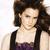 A woman with brown hair in a purple lace top and black straps appears in a of six , with the word "Archie" in pink pixelated text overlaid on the center