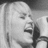 Black-and-white animated sequence showing a person with long hair singing into a microphone, with overlaid text changing across frames.