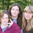 A pixelated group photo of three people in a green outdoor setting with overlaid green text elements on black background.