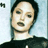 Static 48x48 pixel icon showing a close-up of a person's face with dark hair and light skin, wearing a black top against a pale blue background.