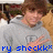 Pixelated image of a person with brown hair wearing a gray shirt, making a hand gesture, with blue text at the bottom reading 'ry sheekk*'.