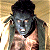Pixelated image of a character with dark hair and gray skin holding an object, next to green text reading "Original Icons .com" on a solid background.