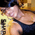 A pixelated image of a person in a dark tank top with yellow background and vertical text, showing slight motion between frames.