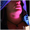 A person with a hooded garment and necklace appears in , showing subtle facial expression changes under pink lighting