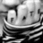 Pixelated grayscale image of a stylized character with large eyes and striped clothing, set against a dark background.