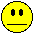 Two yellow pixelated smiley faces side-by-side on gray background; left face has straight black mouth, right face has smiling mouth with red tongue.