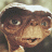 Pixelated image of a small alien with large eyes and textured skin, positioned in the top-left quadrant against a yellow gradient background.