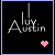 Pixelated text 'Alyx Austin' with a pink heart symbol on black background, bordered by light purple frame.
