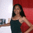 A pixelated image shows a person with long dark hair wearing a dark sleeveless top, standing against a red and white background with a small dark object on the left.