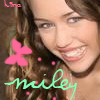 A close-up of a person with long brown hair, smiling with visible teeth, overlaid with pink and green graphic elements including a flower and text.
