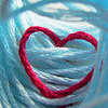 A static icon features a red heart outline centered on a light blue, swirled fabric-like background with subtle white highlights.