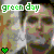 Pixelated static image featuring green text 'green day' above a stylized face with muted earth tones and a small green heart symbol in the corner.