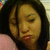Static pixelated image of a person with dark hair, closed eyes, and lips slightly parted against a light background.