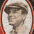 Pixelated portrait of a person with short dark hair wearing a light-colored shirt, framed by a red and white border on a dark background.