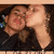 Two people in a close-up pose with one kissing the other on the cheek, displayed across four quadrants of a