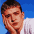 Pixelated static image of a person's face and upper torso against blue sky with white clouds, wearing light-colored shirt.