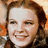 A pixelated image split into two sections: a person with brown hair on the left and yellow text on blue background on the right.