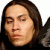 Pixelated close-up of a person with long brown hair, closed eyes, and neutral expression against white background.