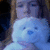 A person holds a light blue teddy bear in four ; the top-right displays 'Hugs!' text overlay