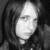 Black-and-white image of a person with long hair on the left, surrounded by four text-based expressions in pixelated font on gray background.