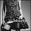 Black-and-white image of a person in a polka-dot dress holding a camera, with the word 'beauty' overlaid in pixelated text.