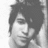 Black-and-white pixelated image divided into four quadrants with a grayscale portrait, text, and symbols.