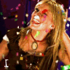 repeated animated frames showing a person with long brown hair, dark top, and necklace against purple background with confetti; text overlays change across frames