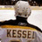 A hockey player in a white jersey with 'KESSEL' on the back, viewed from behind on an ice rink, with yellow text overlays reading 'kessel', 'for', and ''RESIDENT'