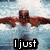 A swimmer in a white swimsuit and dark goggles performs the butterfly stroke in blue water, with text overlays reading "I just Want to FLY"