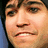A static image with a blue background, featuring a pixelated close-up of a person's face on the left and white text arranged in four sections.