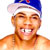 Pixelated static image of a smiling person wearing a blue and white cap with visible teeth, orange skin tone, and no shirt.