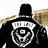 Pixelated character wearing black top hat and dark coat with light brown shoulder accents, featuring a white circular emblem with concentric rings on chest.