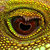 A pixelated circular icon with a central dark core surrounded by layered brown and green rings on a yellowish background.
