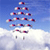 Pixelated static icon showing a parachute jump scene with multiple parachutes against blue sky and white clouds, rendered in low-resolution 256x256 pixels.