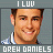 Two side-by-side pixelated images of a smiling man with short brown hair, wearing a light blue and white striped shirt, with text above and below.