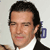 Static 50x50 pixel icon showing a close-up of a man's face with dark hair, wearing a white shirt and black jacket against a light background.