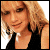 Pixelated image of a person with light brown hair wearing a black top, split into two side-by-side showing identical poses