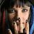 A pixelated image of a person with dark hair and blue streaks holding fingers near their mouth, next to red text reading "Don't Think About It..." on black background.