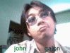 A person with dark hair and glasses appears in four with slight head movements, wearing a light-colored shirt with green text reading 'john' and 'galon' at the bottom