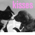 Animated sequence of two black-and-white cats kissing, with pink 'kisses' text above them on a gray background.